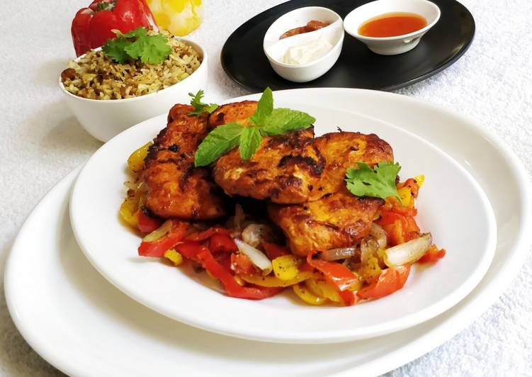 Tasty And Delicious of Pan Fried Chicken Breast on a bed of Pepper&#39;s and Onion