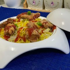 A picture of Arabian rice with popcorn chicken.