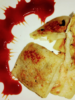 A picture of Suji crepes with vegetables stuffing.