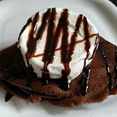 A picture of Non fermented chocolate Dosa with ice cream and chocolate sauce.