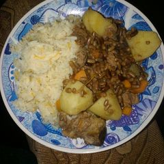 A picture of Carroted rice with special ndengu and beef.