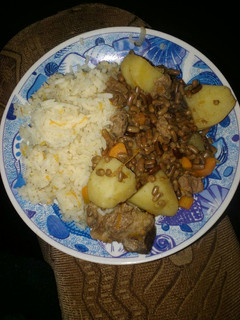 A picture of Carroted rice with special ndengu and beef.