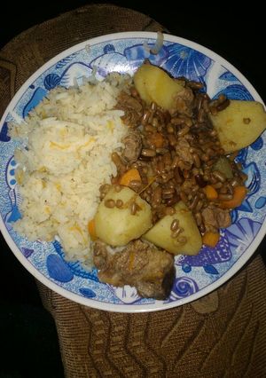 A picture of Carroted rice with special ndengu and beef.