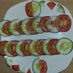 A picture of Tomato and cucumber salad.