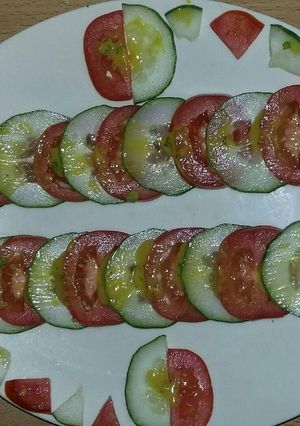 A picture of Tomato and cucumber salad.