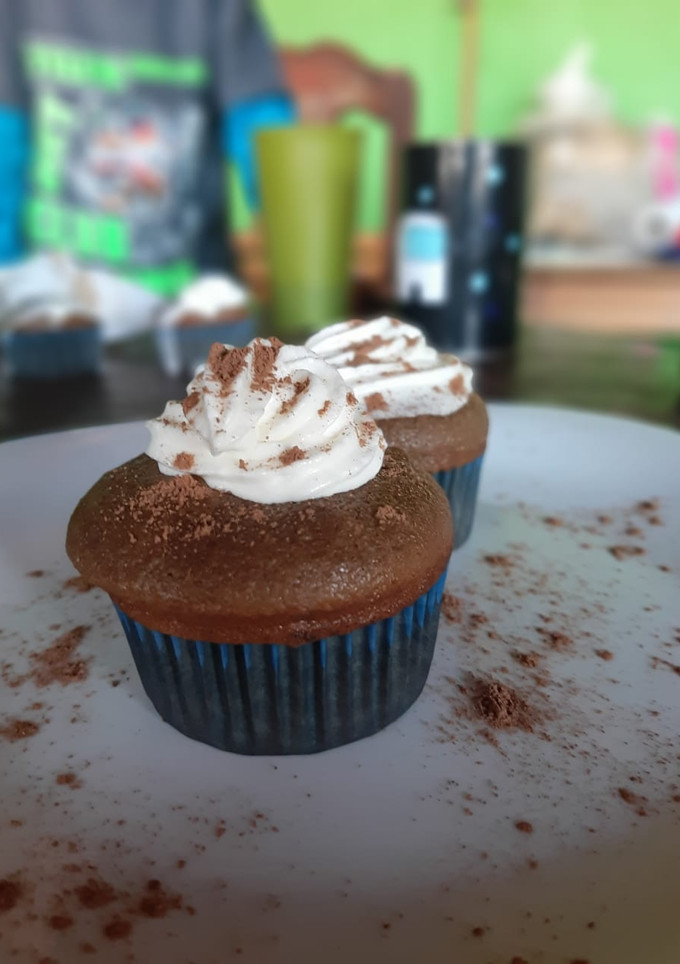 A picture of Mocha Muffins with Whipped Cream Topping.