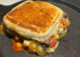 Sanduíche prensado com carne, queijo e legumes