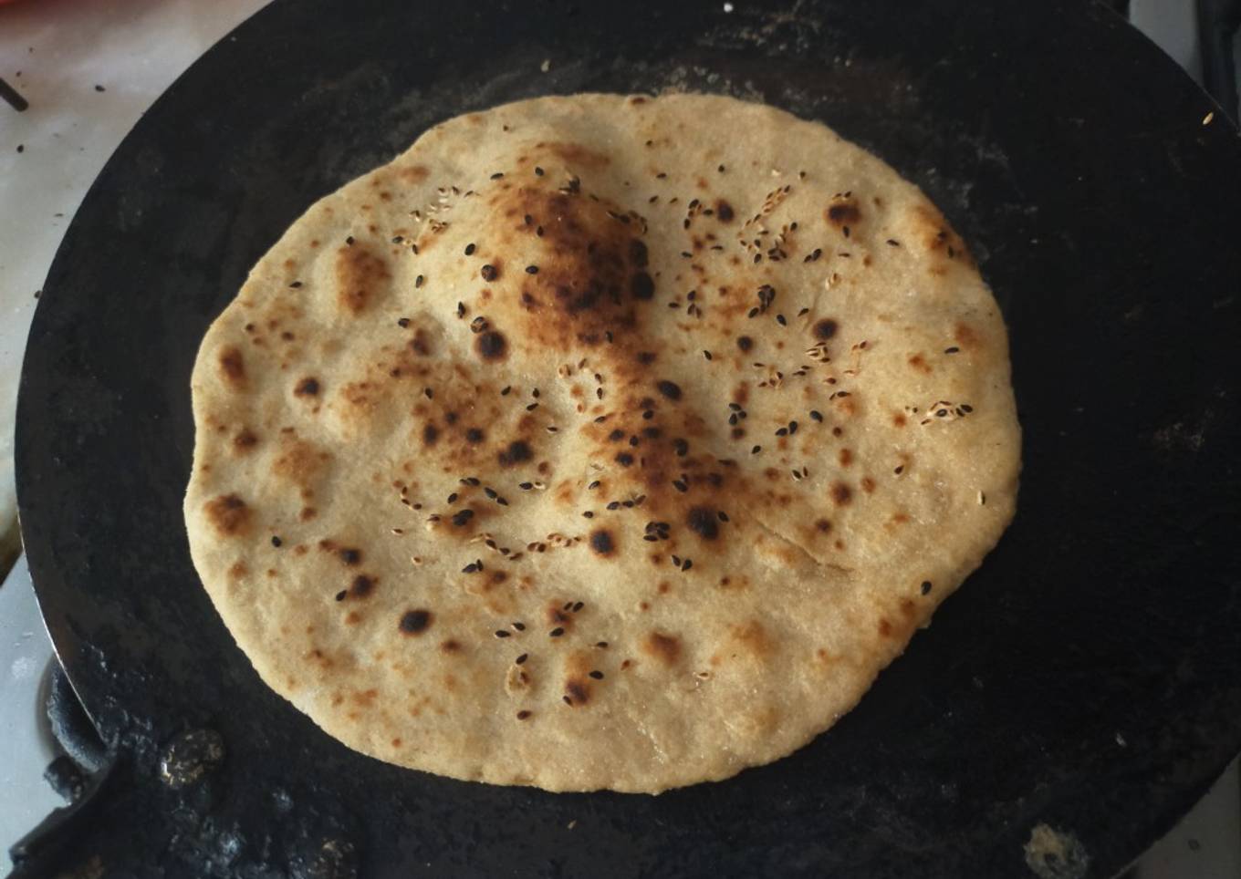 Whole wheat (laal atta) sesame seeds naan on tawa