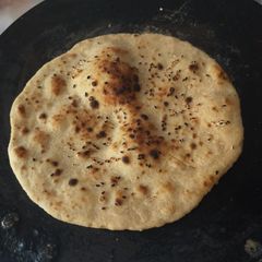 Whole wheat (laal atta) sesame seeds naan on tawa A picture of Whole wheat (laal atta) sesame seeds naan on tawa.