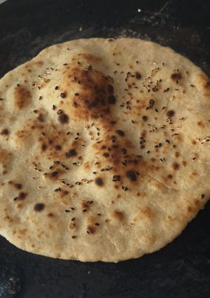A picture of Whole wheat (laal atta) sesame seeds naan on tawa.