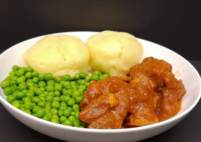 Lamb neck stew with mashed potatoes, and peas