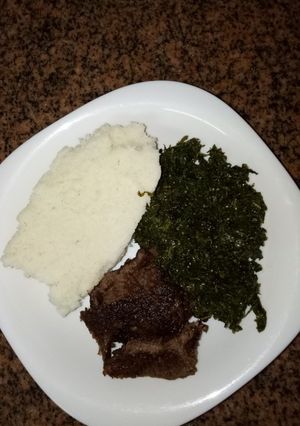 A picture of Ugali, sufuria grilled beef and green#author marathon.