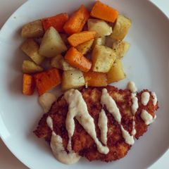A picture of Chicken schnitzel with roasted veggies.