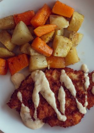 A picture of Chicken schnitzel with roasted veggies.