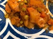 A picture of chicken stew and peas