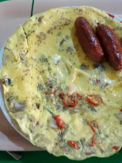 A picture of Fried eggs with sausages.