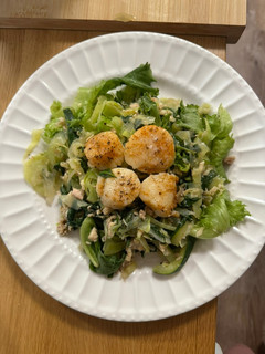 A picture of Steamed Scallops with greens.