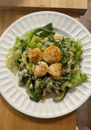 A picture of Steamed Scallops with greens.