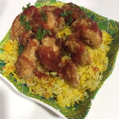 A picture of Yellow rice with crispy chicken.