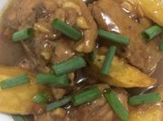 A picture of chicken adobo with potatoes