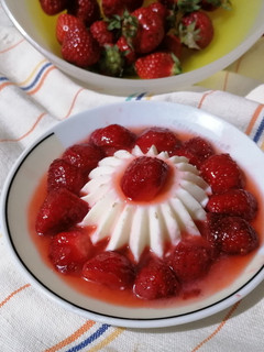 A picture of Panna Cotta with Strawberries.
