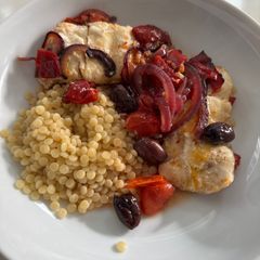 A picture of Baked Italian cod with cherry tomatoes, olives and peppers.