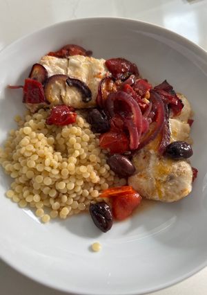 A picture of Baked Italian cod with cherry tomatoes, olives and peppers.