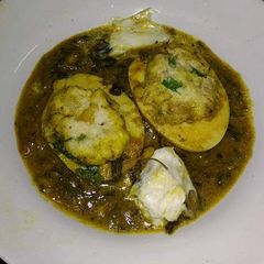 A picture of Malai palak with stuffed eggs.