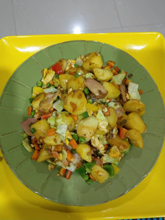 A picture of Potatoes in veggie sauce.