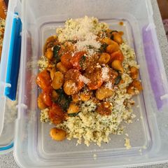 A picture of Butter bean and tomato stew with pesto bulgar and cheese.
