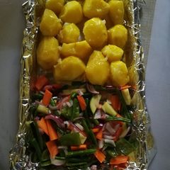 A picture of Baked potatoes and vegetables.