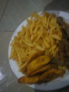A picture of Chips, plantain with chicken pepper soup.