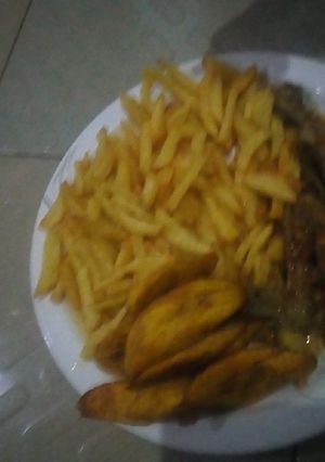 A picture of Chips, plantain with chicken pepper soup.