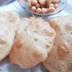 A picture of Puri with white chana.