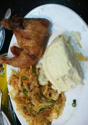 A picture of Fried Chicken, Veges with Ugali.
