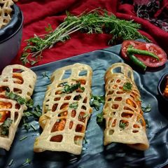 A picture of Moong jaali dosa with tangy paneer filling.