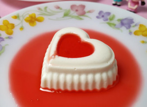 A picture of Panna Cotta With Strawberry syrup.