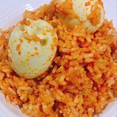 A picture of Jollof rice and boiled egg.