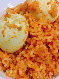 A picture of Jollof rice and boiled egg.