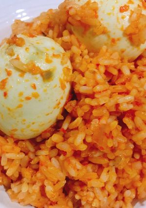 A picture of Jollof rice and boiled egg.