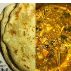 A picture of Naan bread and chicken and potatoes curry.