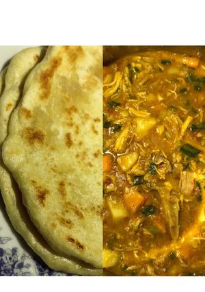 A picture of Naan bread and chicken and potatoes curry.