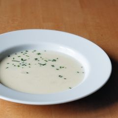 A picture of Asparagus soup with small bits of asparagus.