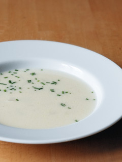 A picture of Asparagus soup with small bits of asparagus.