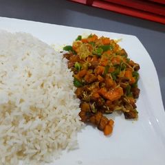 A picture of White rice with vegetable and plantain stew.