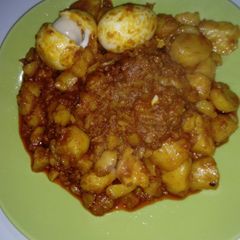 A picture of Irish potatoes porriage Garnished with Boil Eggs.