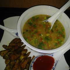 A picture of Sweet corn veg soup with roasted potatoes.