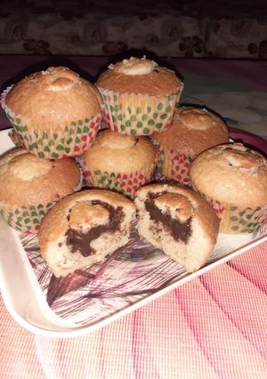 A picture of Chocolate filled vanilla cupcakes.