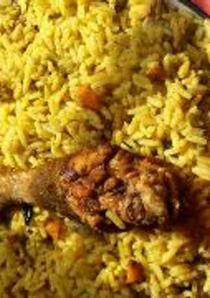 A picture of Fried rice and chicken.