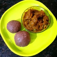 Ragi mudda with mutton curry A picture of Ragi mudda with mutton curry.